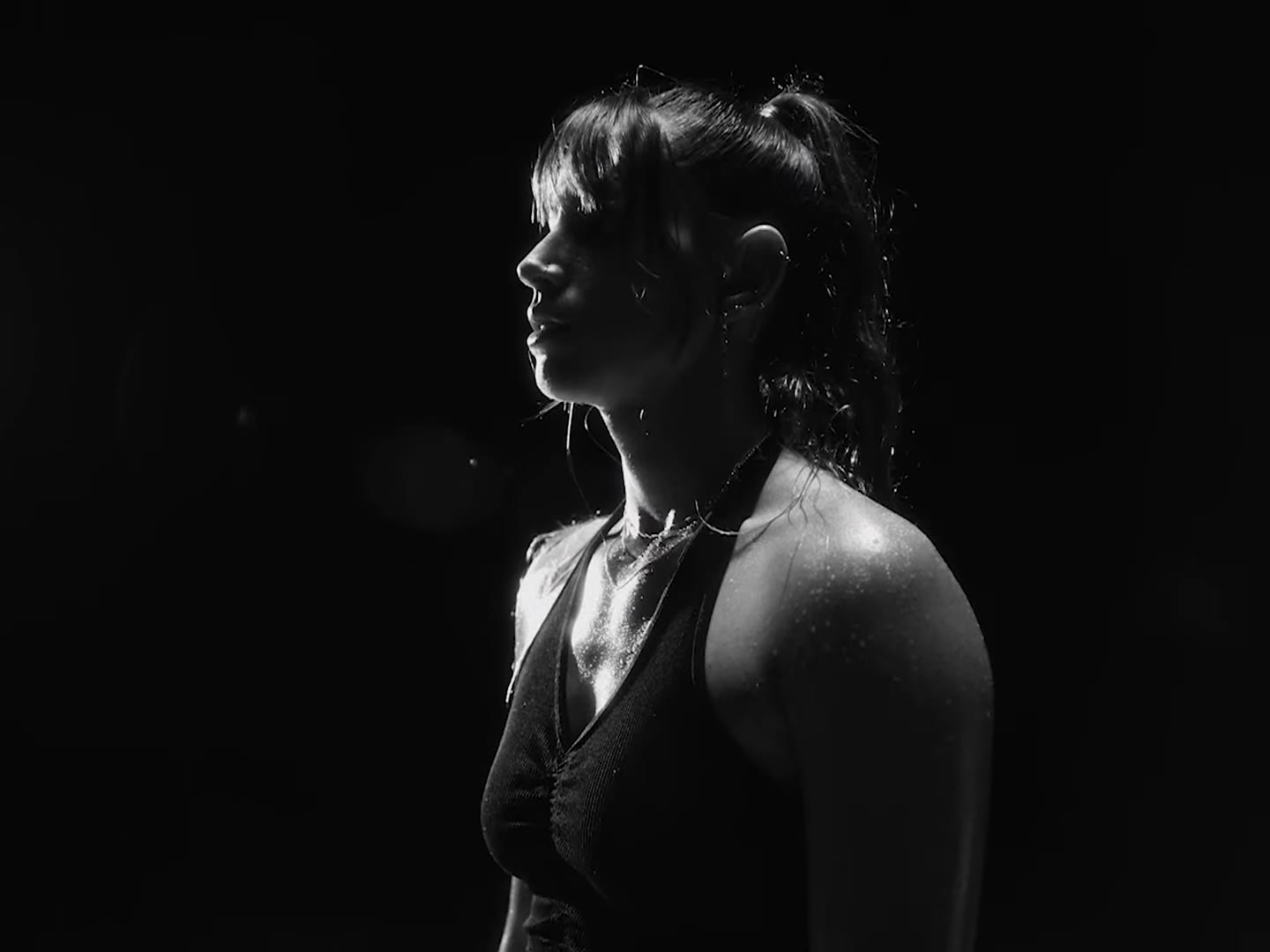 A study in strength: the neck and shoulder of an athlete in raking light.